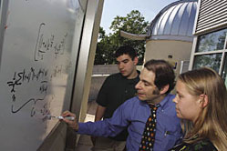Dr. Harold Geller writes on a whiteboard