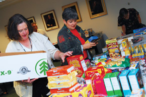 Susan Kehoe-Laptew and Denise Napoliello gathering to assemble care packages for the troops