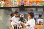 Alessandra Luchini working in the lab with a student.